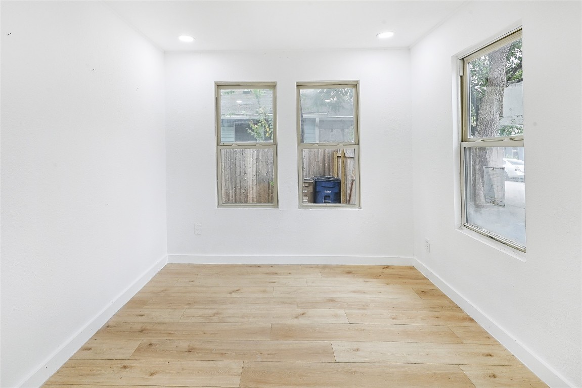 2404 Santa Rita Street Austin, TX 78702 - Photo 5 of 27 Spare room featuring light wood-type flooring and recessed lighting