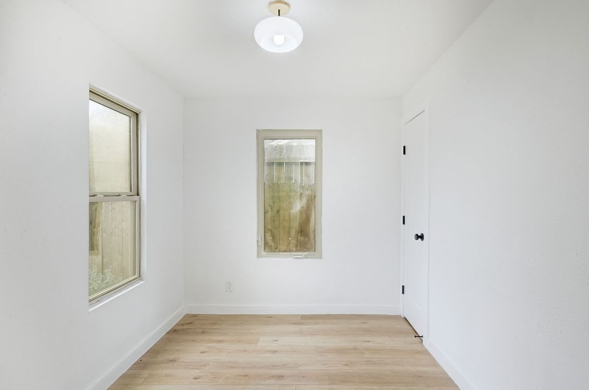 2404 Santa Rita Street Austin, TX 78702 - Photo 7 of 27 Spare room featuring light wood-type flooring and baseboards