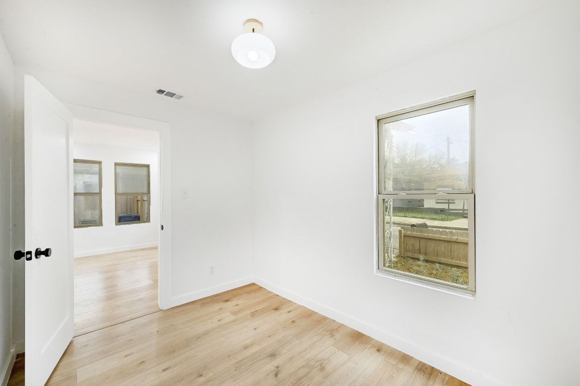 2404 Santa Rita Street Austin, TX 78702 - Photo 8 of 27 Unfurnished room featuring light wood-style flooring and baseboards