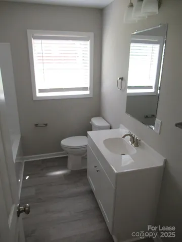 a bathroom with a sink toilet and a mirror
