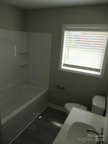 a bathroom with a bathtub and window