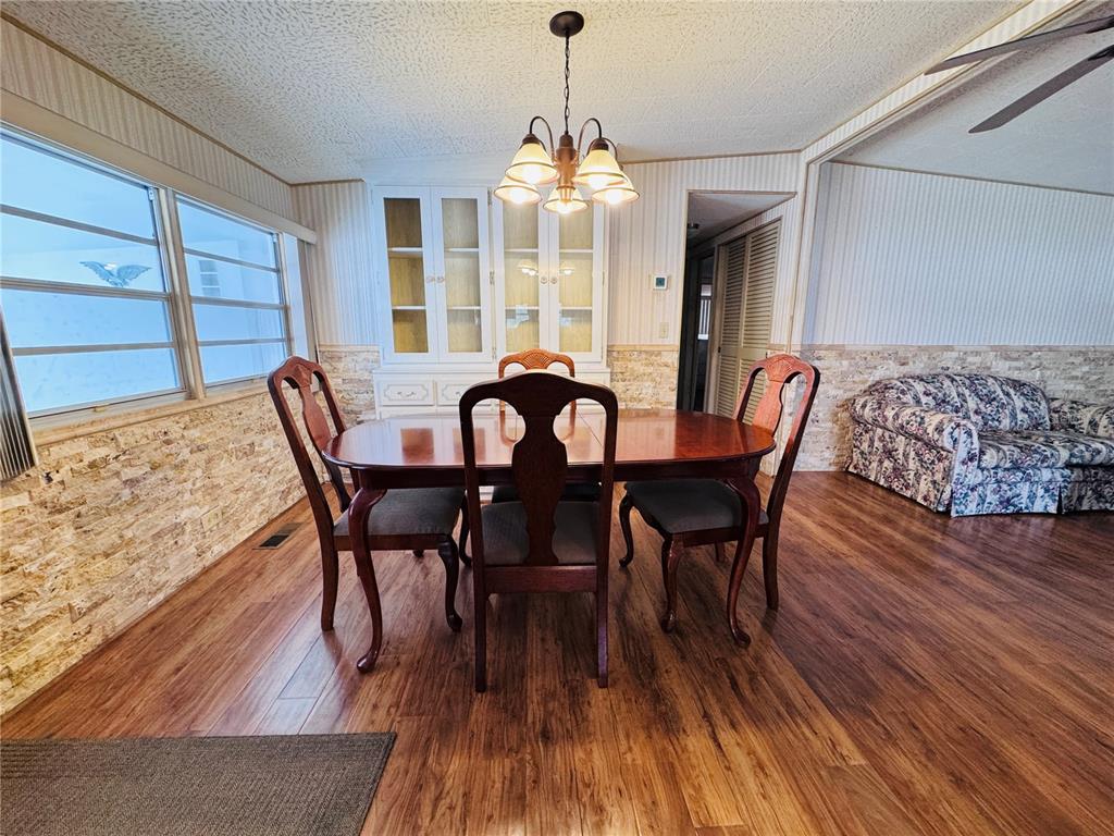 2331 Belleair Road, Unit 715 Clearwater, FL 33764 - Photo 11 of 43 a view of a dining room with furniture window and wooden floor