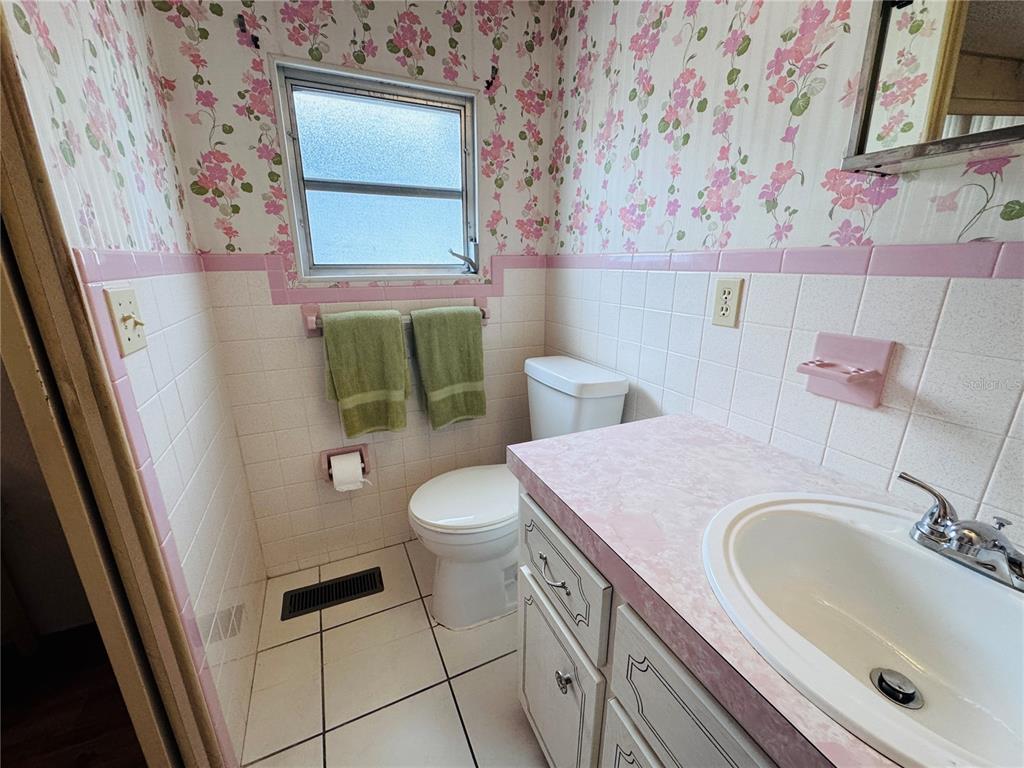 2331 Belleair Road, Unit 715 Clearwater, FL 33764 - Photo 22 of 43 a bathroom with a sink a toilet and a mirror