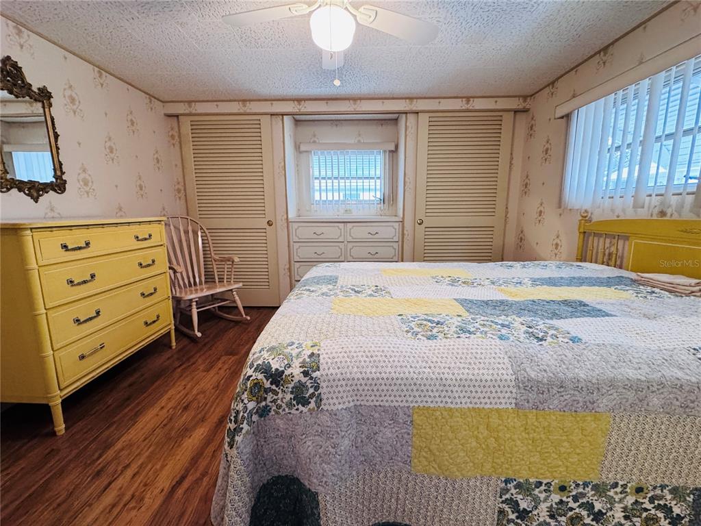 2331 Belleair Road, Unit 715 Clearwater, FL 33764 - Photo 23 of 43 a bedroom with a bed and wooden floor