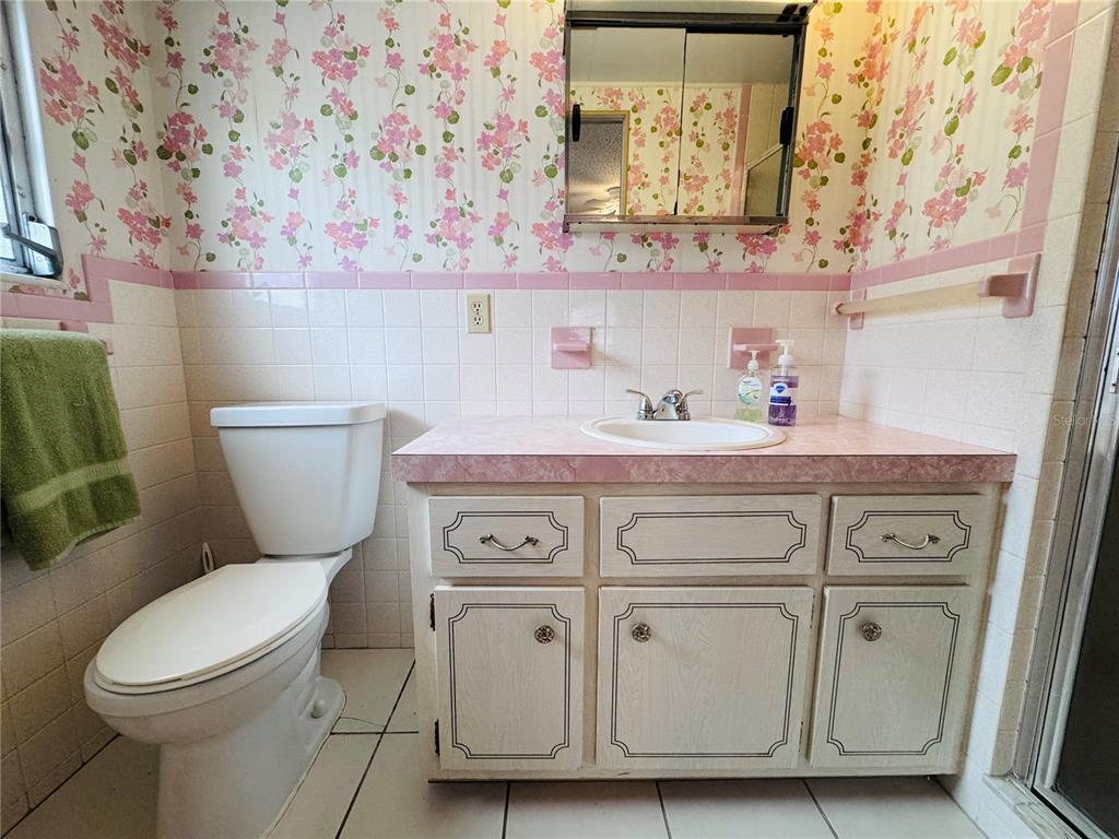 2331 Belleair Road, Unit 715 Clearwater, FL 33764 - Photo 25 of 43 a bathroom with a toilet a sink and wooden floor