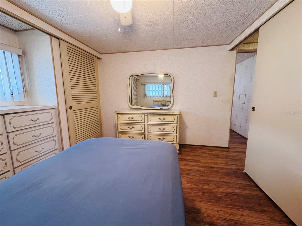 2331 Belleair Road, Unit 715 Clearwater, FL 33764 - Photo 27 of 43 a bedroom with a bed and a dresser in it