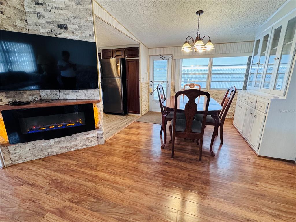 2331 Belleair Road, Unit 715 Clearwater, FL 33764 - Photo 3 of 43 a dining room with furniture a fireplace and wooden floor