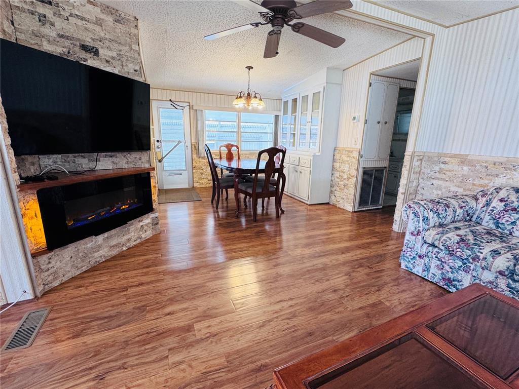 2331 Belleair Road, Unit 715 Clearwater, FL 33764 - Photo 10 of 43 a living room with furniture a flat screen tv and a fireplace