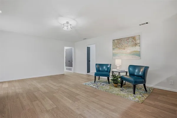 a view of a livingroom with chair and wooden floor