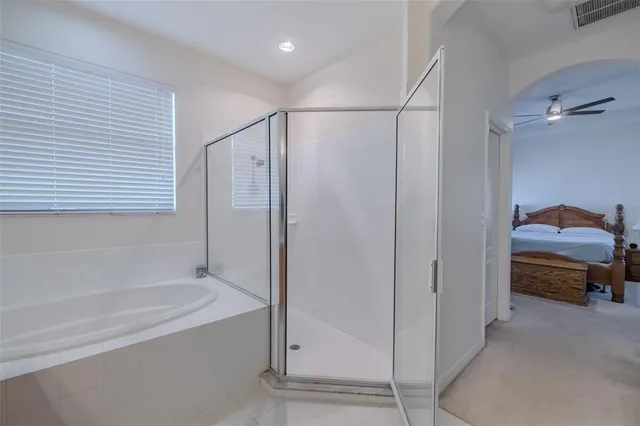 a en suite bathroom with a tub and shower