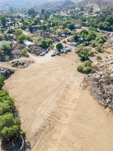 a view of a dry yard with plants and lake view