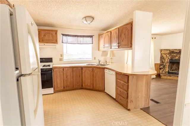 a kitchen with a refrigerator sink and cabinets