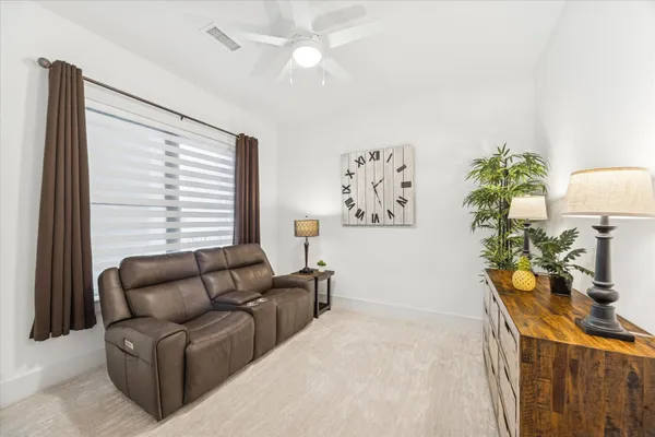 a bedroom with a bed a large window and a flat screen tv