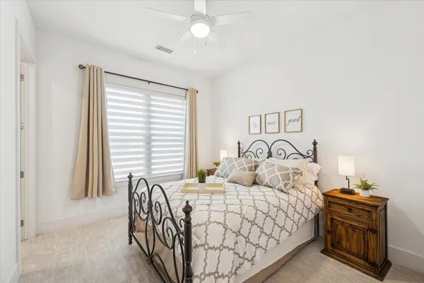 a bed sitting in a bedroom next to a window