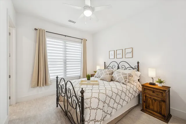 a bed sitting in a bedroom next to a window