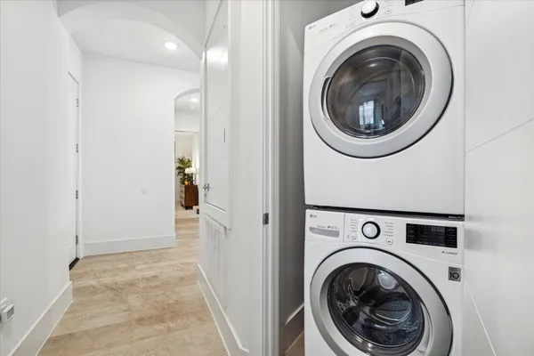 a living room with furniture large windows and wooden floor