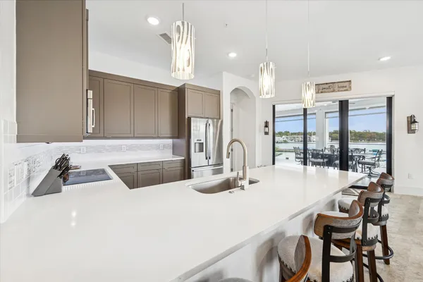 a kitchen with sink a microwave and cabinets