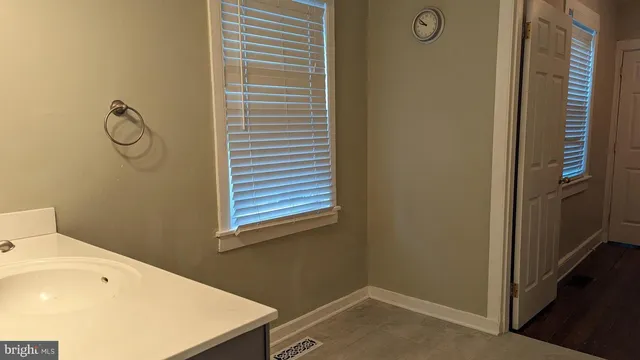 a bathroom with a sink and a window