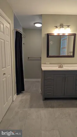 a bathroom with a double vanity sink and mirror