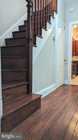 a view of a hallway with a dining room and stairs