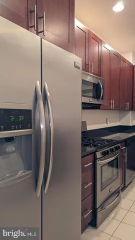a stove top oven sitting inside of a kitchen and granite counter tops