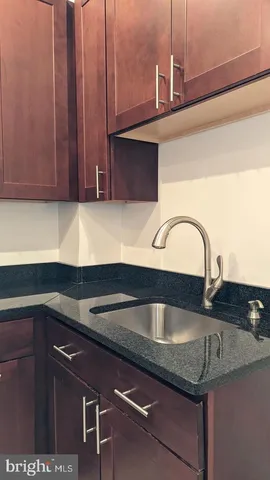 a view of a hallway with wooden floor and closet
