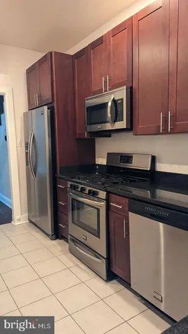 a kitchen with a refrigerator sink and stove