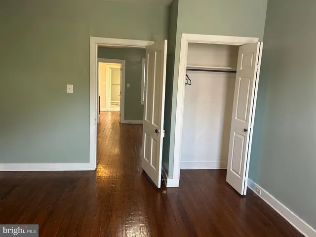 a view of a room with wooden floor