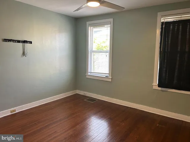 a view of a room with wooden floor and windows