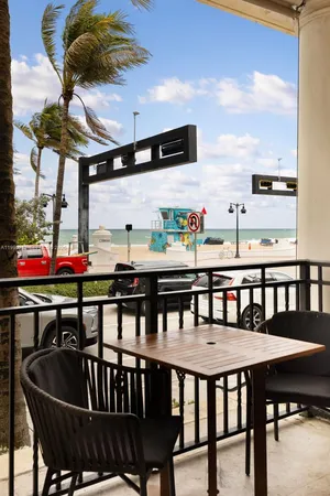 a roof deck with a table and chairs
