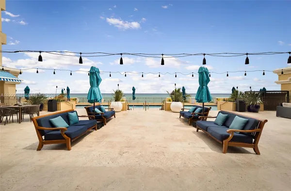 a view of a swimming pool with outdoor seating