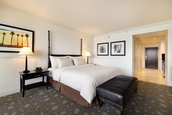 a bedroom with bed and night stand