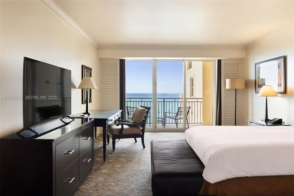 a bedroom with furniture and a flat screen tv
