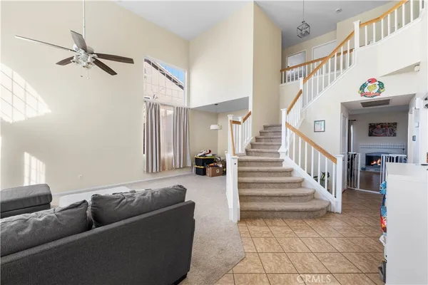 a living room with furniture and stairs