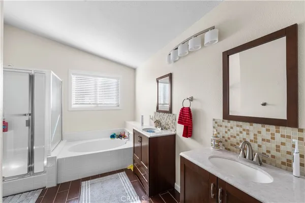 a bathroom with a tub sink and mirror