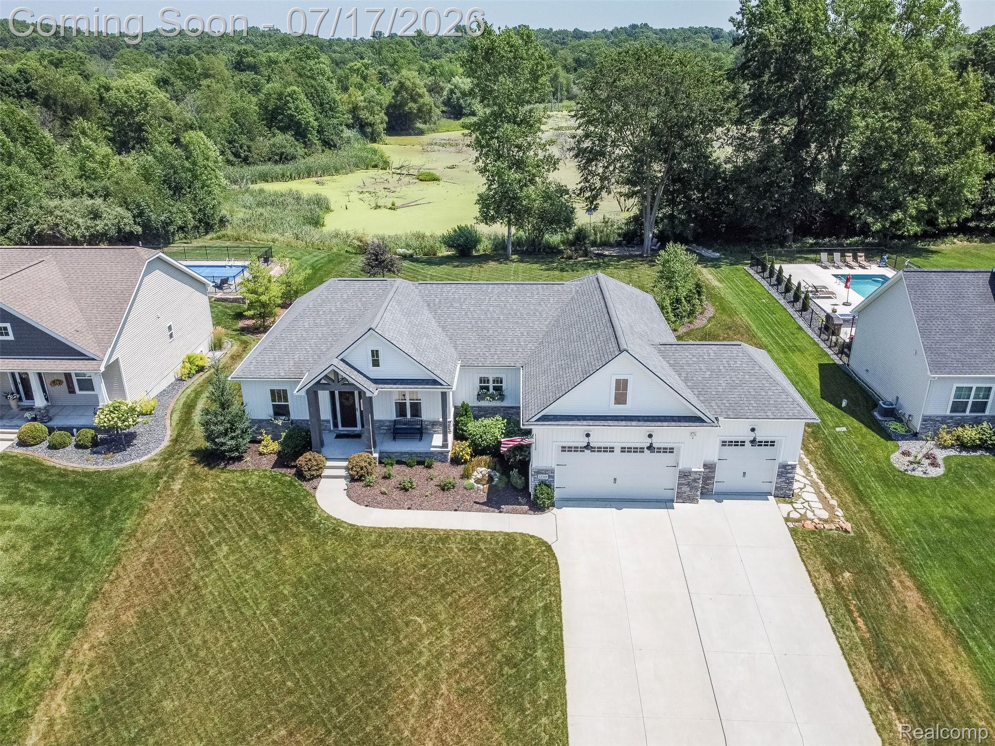 12349 Sugar Maple Drive Fenton, MI 48430 - Photo 62 of 67 Contemporary ranch-style residence featuring a gray shingle roof, white siding, and a stone facade