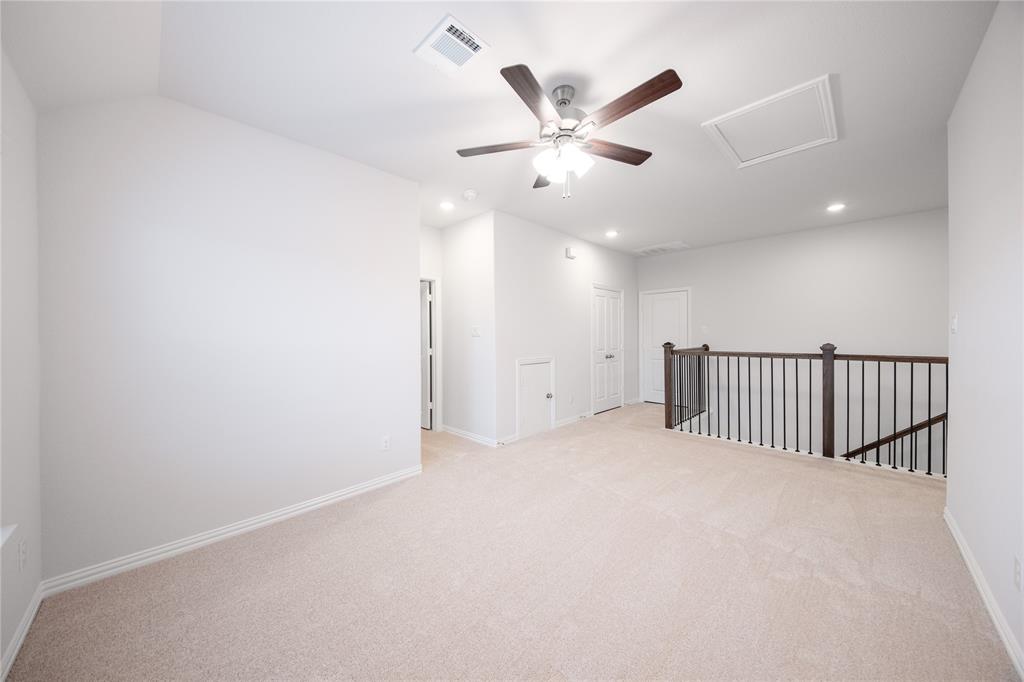 2606 Hawkins Street Anna, TX 75409 - Photo 7 of 31 an empty room with windows and fan