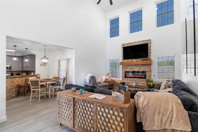 a living room with furniture a fireplace and a flat screen tv