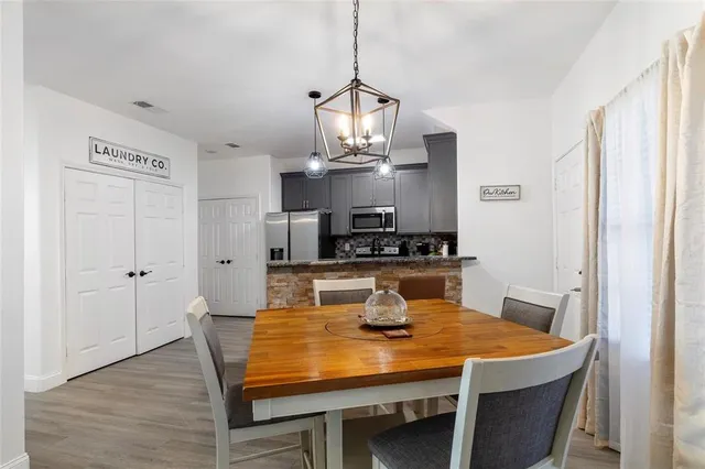 a view of a dining room with a table and chairs