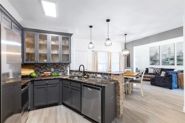 a kitchen with a sink stove and wooden cabinets
