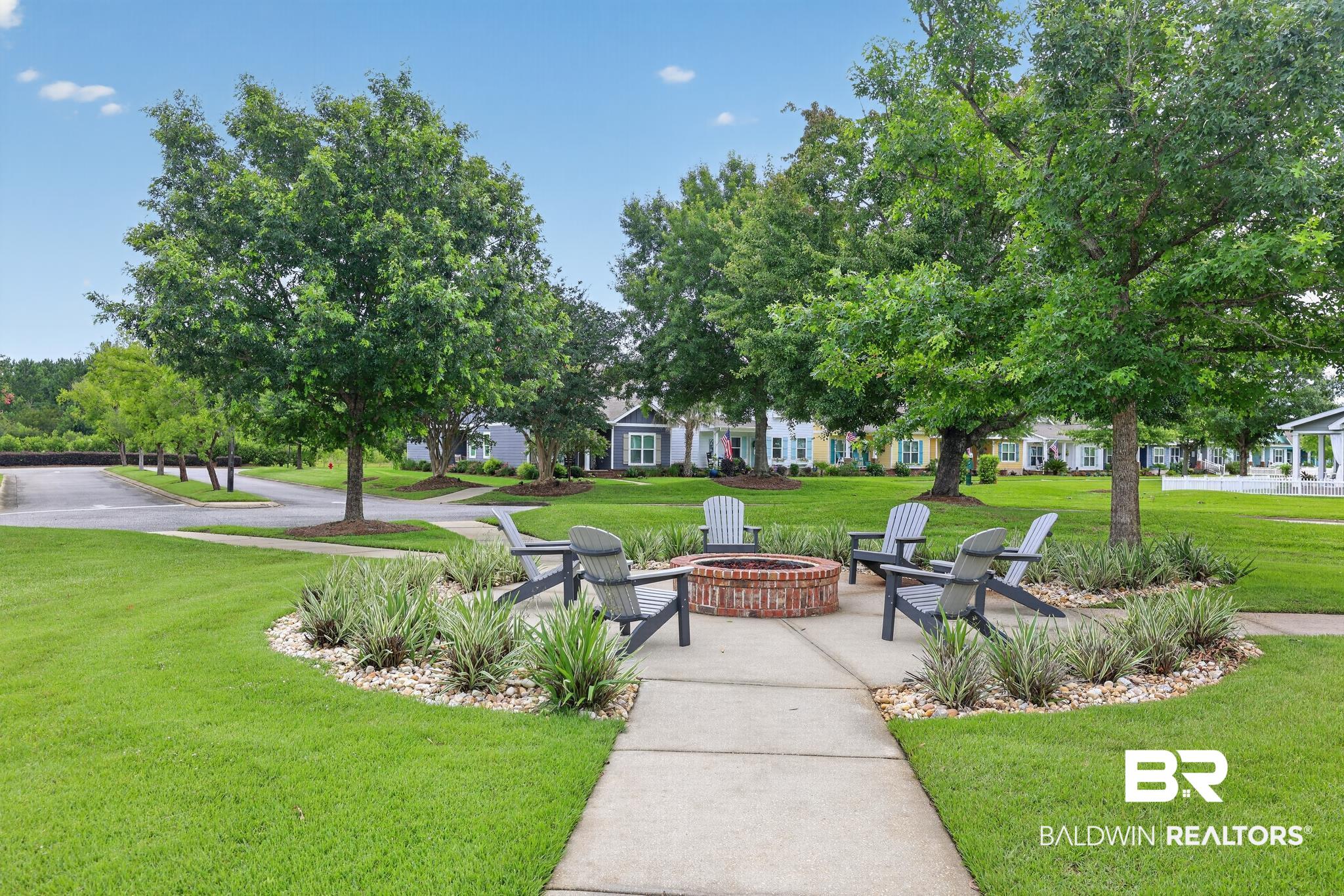 1210 Primrose Lane Foley, AL 36535 - Photo 32 of 33 Central fire pit area featuring a brick-lined fire pit and surrounding Adirondack-style seating