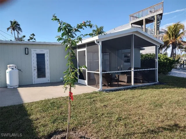 a view of a house with a window and potted plants