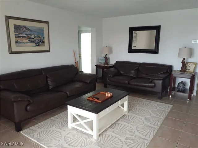 a living room with furniture and a rug