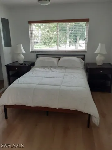 a bedroom with a bed and window