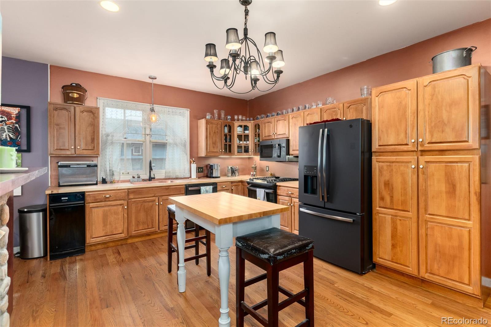 200 Rose Street Georgetown, CO 80444 - Photo 27 of 43 a kitchen with stainless steel appliances granite countertop a refrigerator a sink dishwasher a stove a refrigerator and a dining table with wooden floor