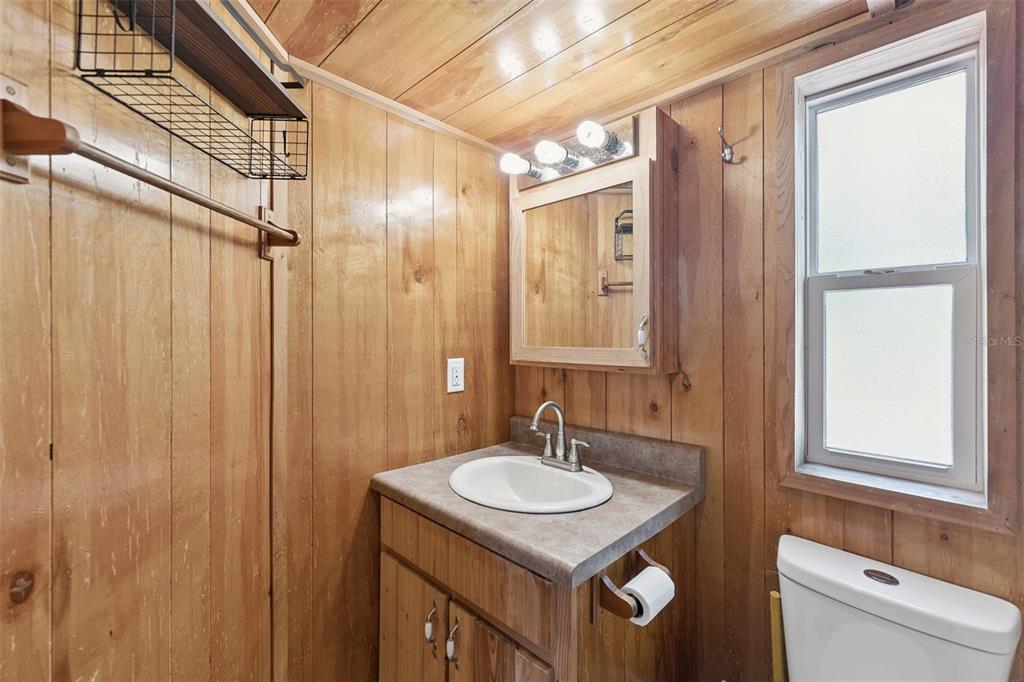 1140 Buckles Road Pierson, FL 32180 - Photo 15 of 39 a bathroom with a sink a mirror and a shower