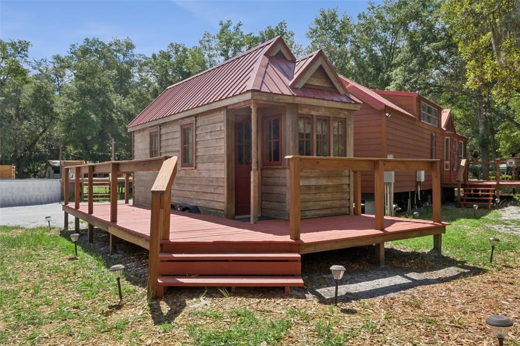 1140 Buckles Road Pierson, FL 32180 - Photo 18 of 39 a backyard of a house with barbeque oven table and chairs