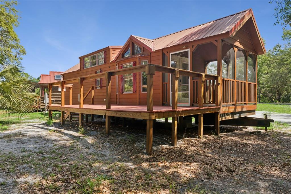 1140 Buckles Road Pierson, FL 32180 - Photo 4 of 39 a wooden house with a large trees and wooden fence