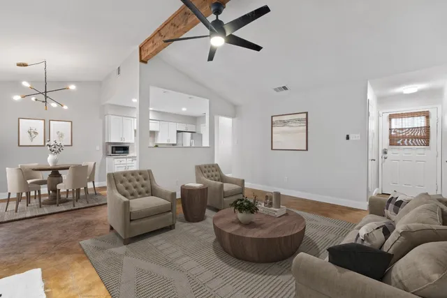 a living room with furniture and a chandelier
