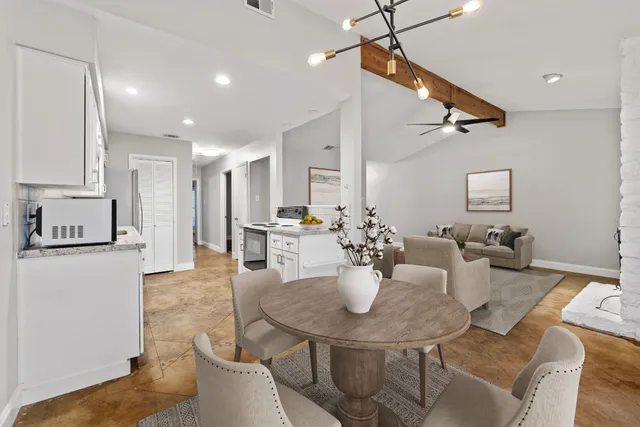 a view of a dining room and livingroom with furniture